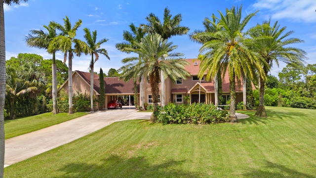 mediterranean / spanish home with a front yard