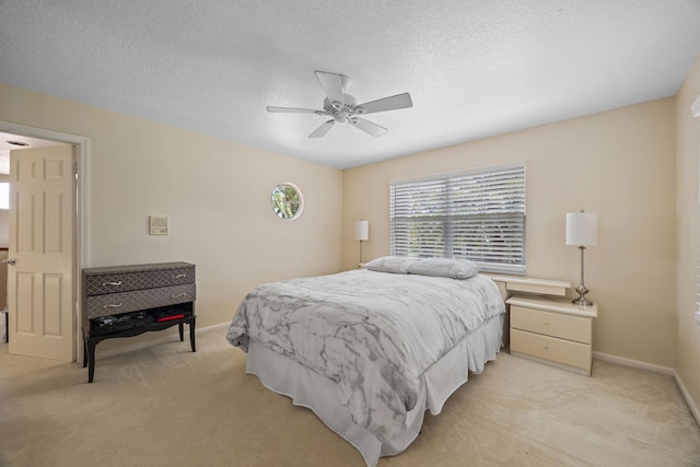 bedroom with light carpet, a textured ceiling, and ceiling fan