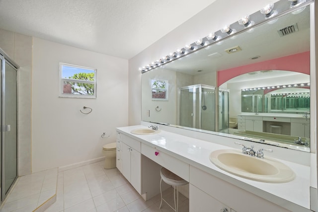 bathroom featuring walk in shower, vanity, a textured ceiling, tile patterned flooring, and toilet