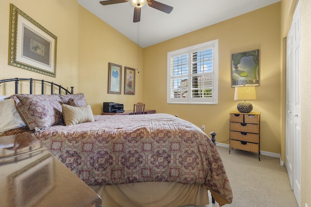 carpeted bedroom featuring ceiling fan, a closet, and lofted ceiling