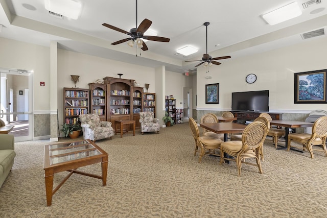 carpeted living room featuring ceiling fan