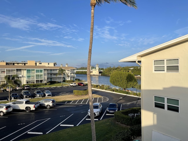 view of parking / parking lot with a water view