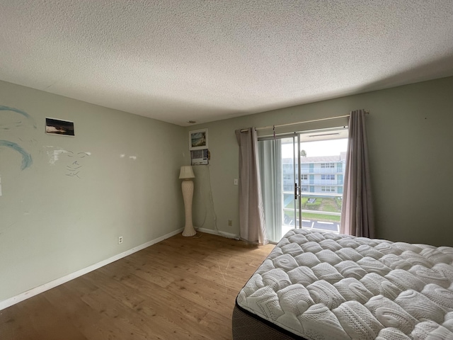 unfurnished bedroom with light hardwood / wood-style floors and a textured ceiling