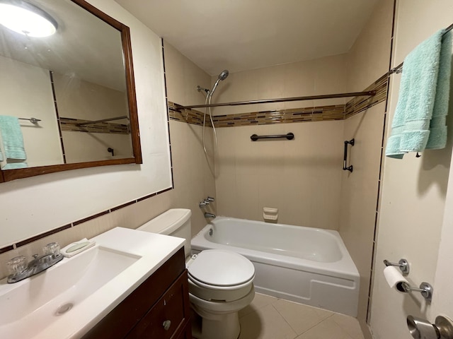 full bathroom featuring toilet, vanity, tiled shower / bath, and tile patterned flooring