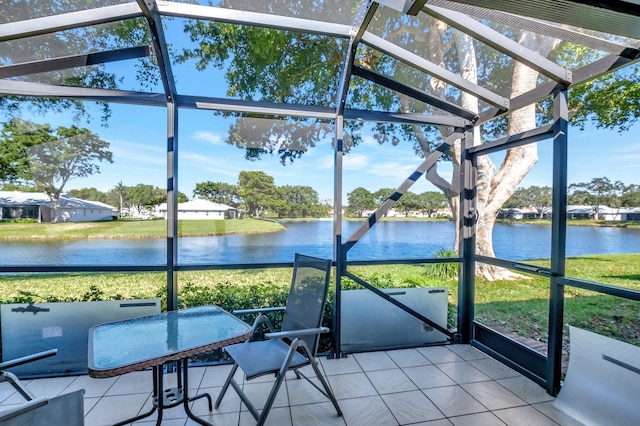 sunroom / solarium featuring a water view