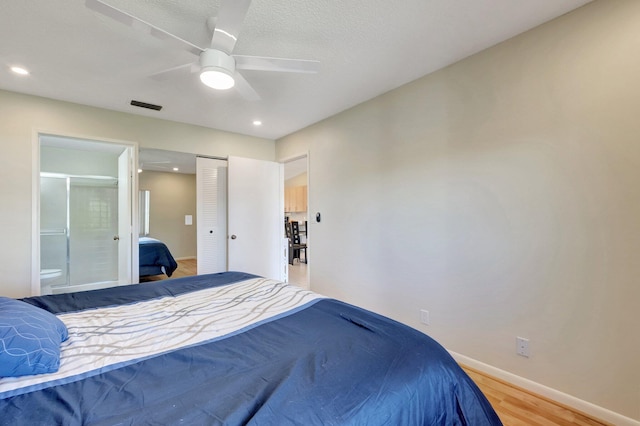 bedroom featuring ensuite bathroom, ceiling fan, and wood-type flooring