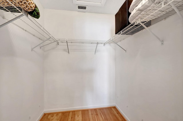 walk in closet featuring hardwood / wood-style floors