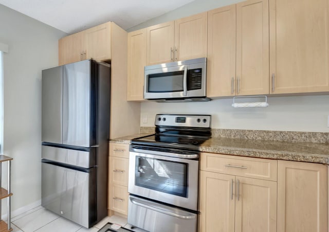 kitchen featuring light brown cabinets and appliances with stainless steel finishes