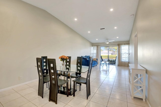 tiled dining space with ceiling fan and lofted ceiling