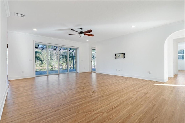 unfurnished living room featuring ceiling fan, ornamental molding, and light hardwood / wood-style flooring