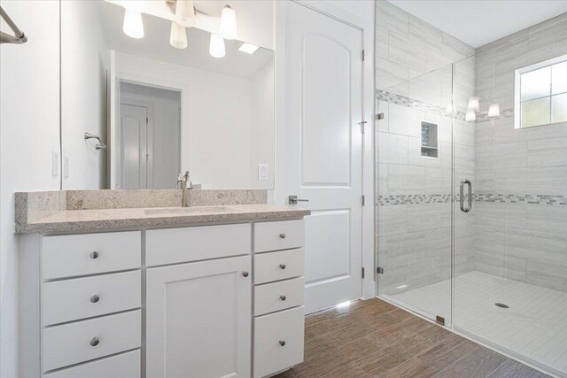 bathroom with vanity, toilet, and a shower with shower door