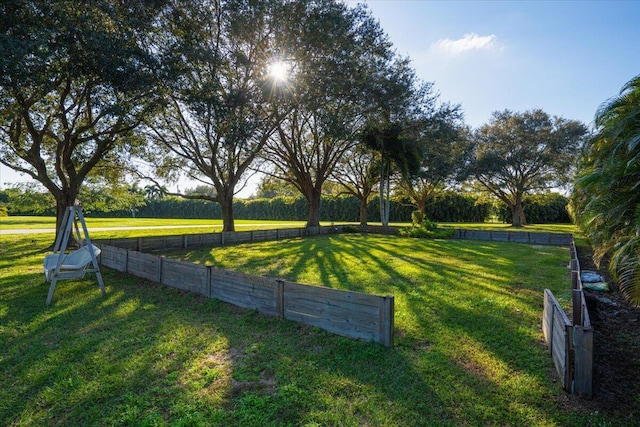 view of community with a lawn and a rural view