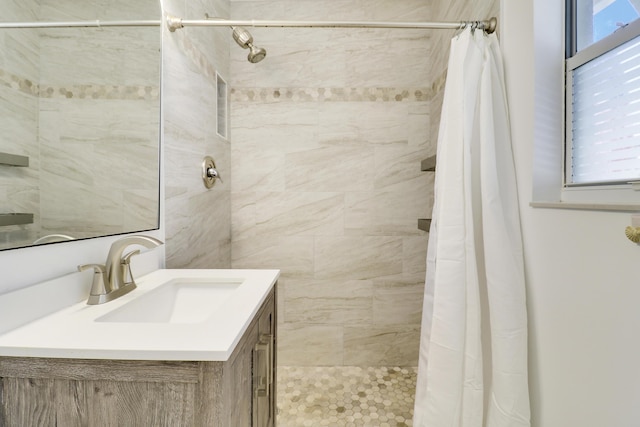 bathroom featuring a shower with curtain and vanity