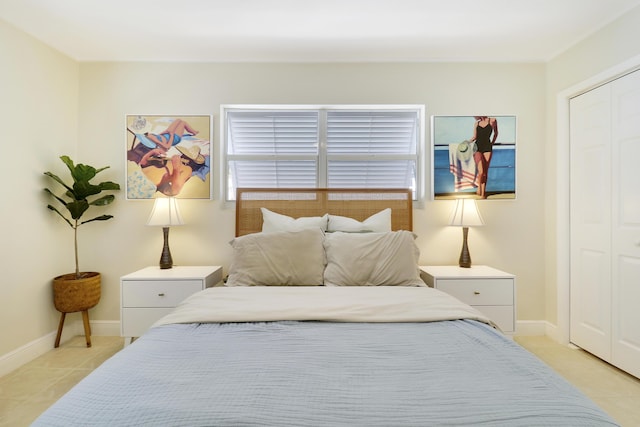 tiled bedroom with a closet