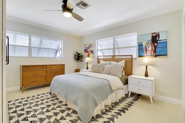 bedroom with ceiling fan and light tile patterned floors