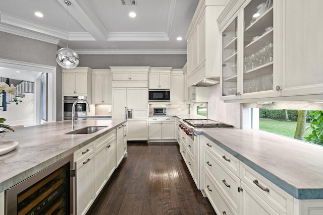 kitchen with wine cooler, sink, built in appliances, decorative light fixtures, and backsplash