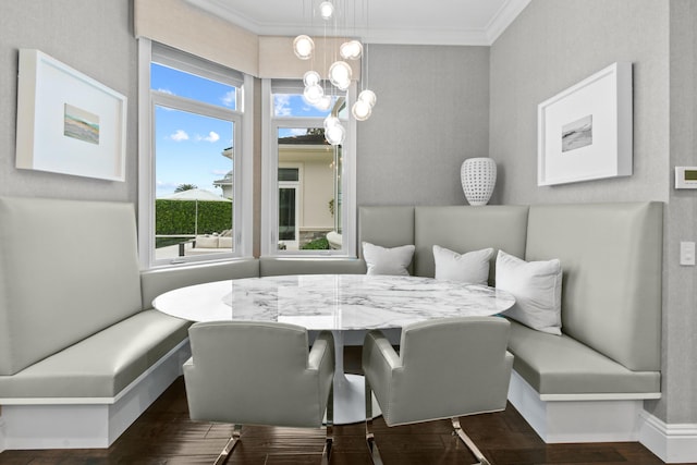 dining space featuring ornamental molding and breakfast area