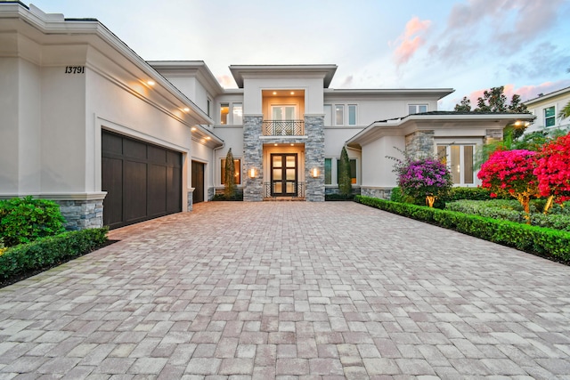 view of front of house with a garage and a balcony