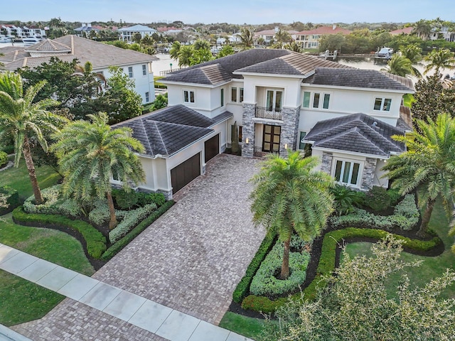 view of front of property with a garage and a balcony