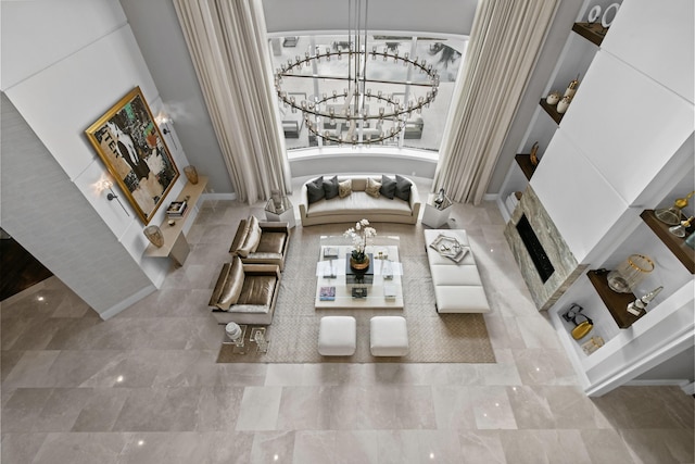 unfurnished living room with an inviting chandelier and a fireplace