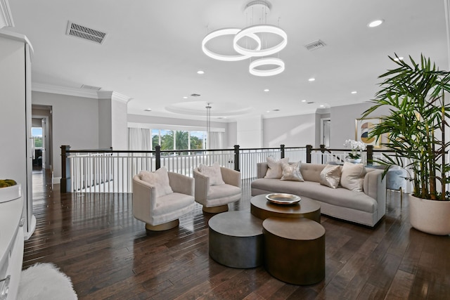 living room with crown molding, dark hardwood / wood-style flooring, and a chandelier