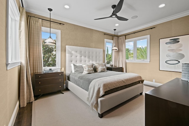 bedroom with ornamental molding, hardwood / wood-style floors, and ceiling fan