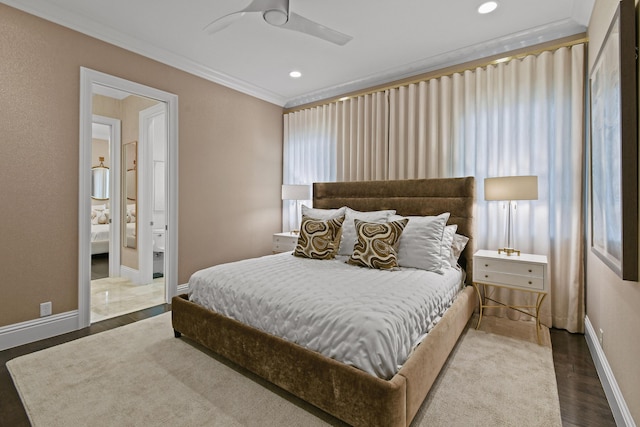 bedroom featuring hardwood / wood-style flooring, ceiling fan, ornamental molding, and ensuite bath