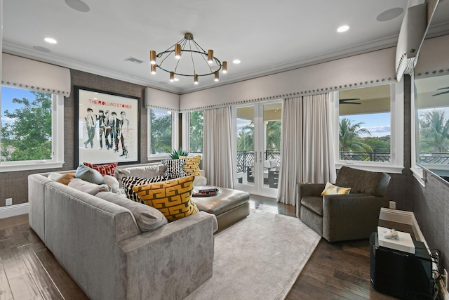 living room featuring an inviting chandelier, crown molding, and dark hardwood / wood-style floors