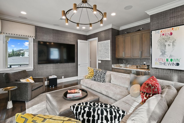 living room featuring sink, dark wood-type flooring, ornamental molding, and a chandelier