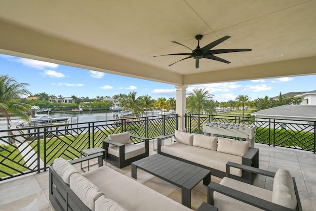 view of patio featuring a water view, ceiling fan, outdoor lounge area, and a balcony