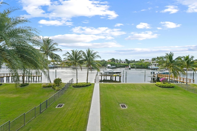 view of yard with a water view and a dock