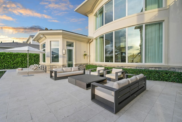 13791 Baycliff Dr, Juno Beach, FL 33408 - patio terrace at dusk featuring outdoor lounge area