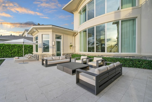 patio terrace at dusk featuring outdoor lounge area