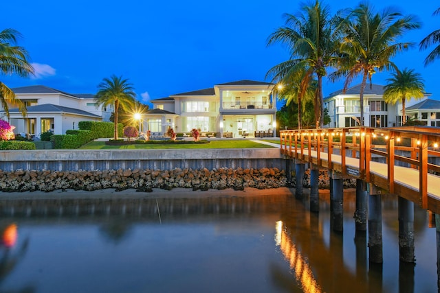 exterior space featuring a balcony and a water view