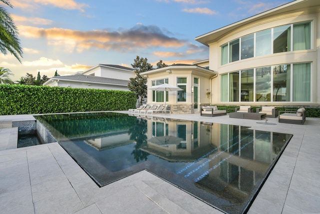 13791 Baycliff Dr, Juno Beach, FL 33408 - pool at dusk with a patio