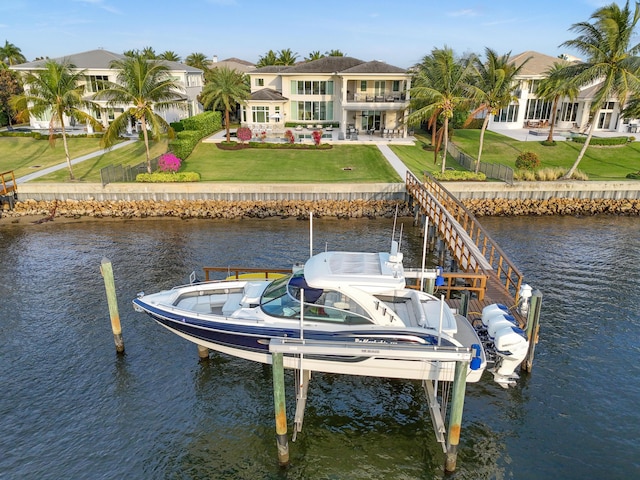 dock area with a water view and a yard