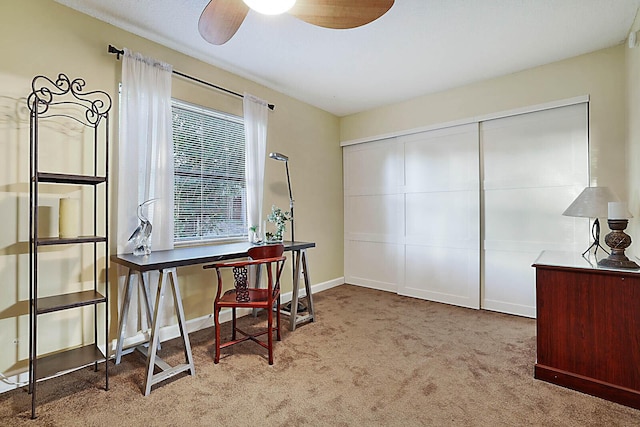 carpeted office featuring ceiling fan