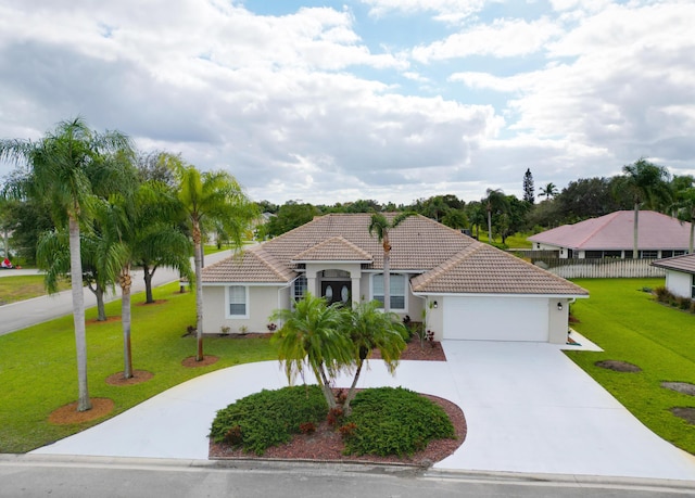 view of front of property with a garage and a front lawn