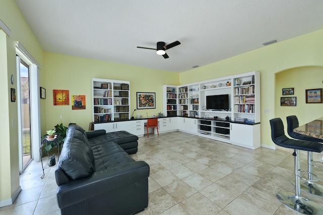 living room with light tile patterned floors, ceiling fan, and a healthy amount of sunlight