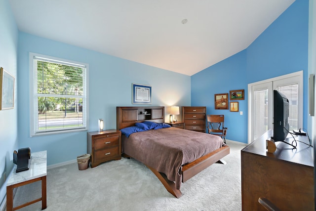 carpeted bedroom with lofted ceiling