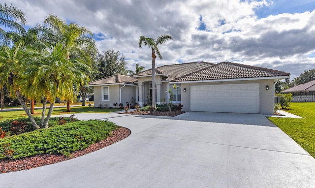 mediterranean / spanish-style house featuring a garage and a front lawn