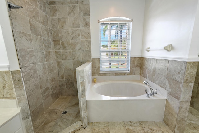 bathroom featuring separate shower and tub and tile walls