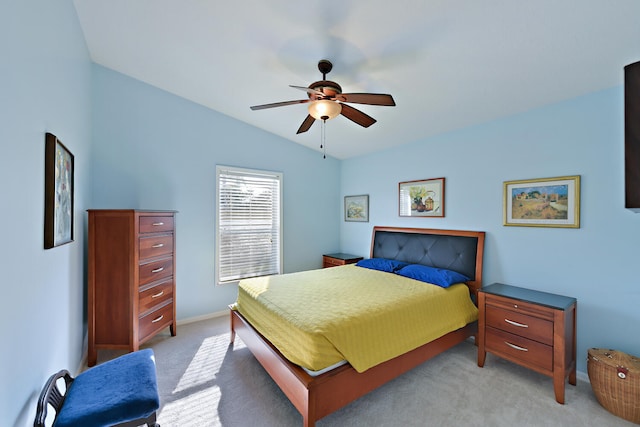 bedroom with ceiling fan, light colored carpet, and vaulted ceiling