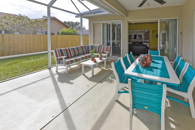 sunroom featuring ceiling fan