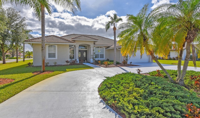 mediterranean / spanish-style house featuring a front lawn