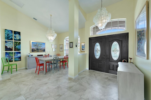 entryway with a chandelier and high vaulted ceiling