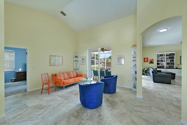 living room featuring high vaulted ceiling