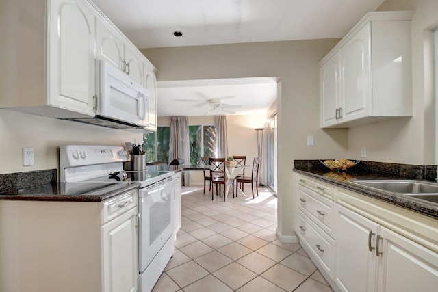 kitchen with white appliances, ceiling fan, white cabinets, and light tile patterned floors