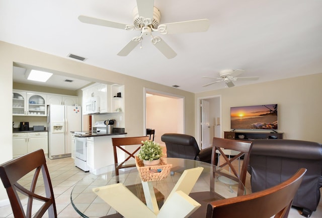 tiled dining area featuring ceiling fan