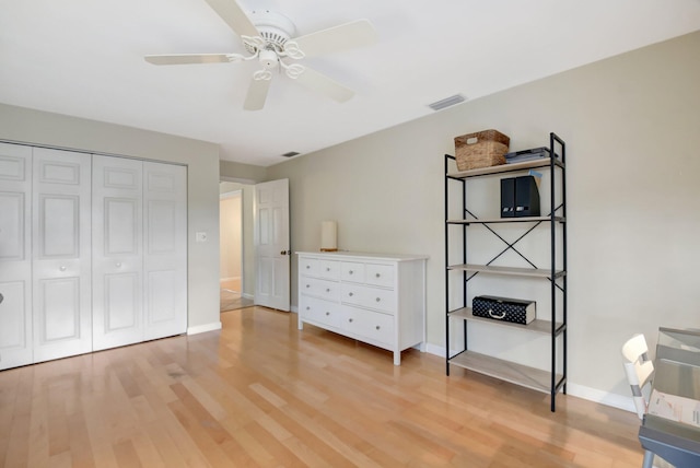 unfurnished bedroom with ceiling fan, a closet, and wood-type flooring